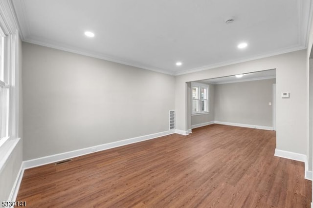 empty room featuring crown molding and hardwood / wood-style floors