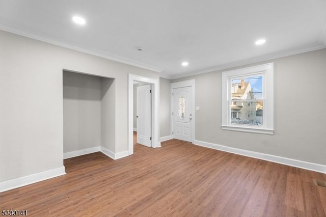 interior space featuring hardwood / wood-style flooring and crown molding