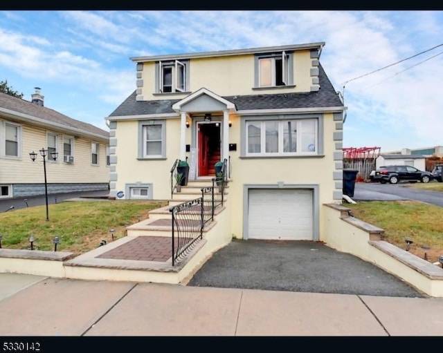 view of front of property with a front yard and a garage