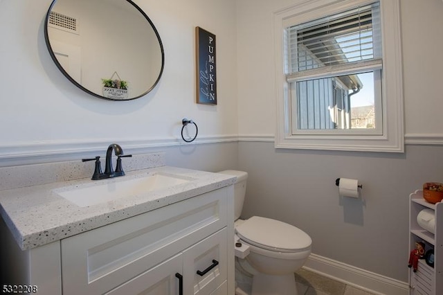 bathroom featuring vanity and toilet