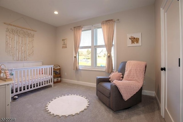 bedroom with light carpet and a nursery area