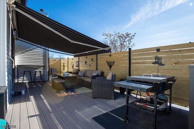 deck with an outdoor living space and area for grilling