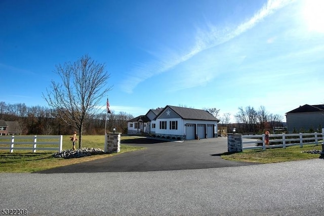 view of front of home with a front lawn and a garage