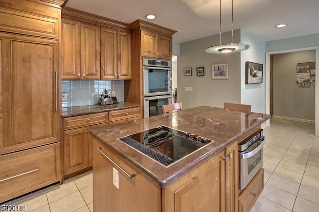 kitchen featuring a center island, tasteful backsplash, stainless steel double oven, black electric stovetop, and pendant lighting