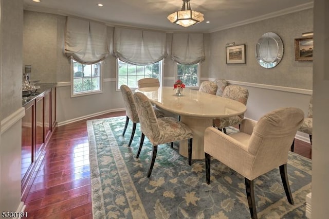 dining area featuring ornamental molding and dark hardwood / wood-style floors