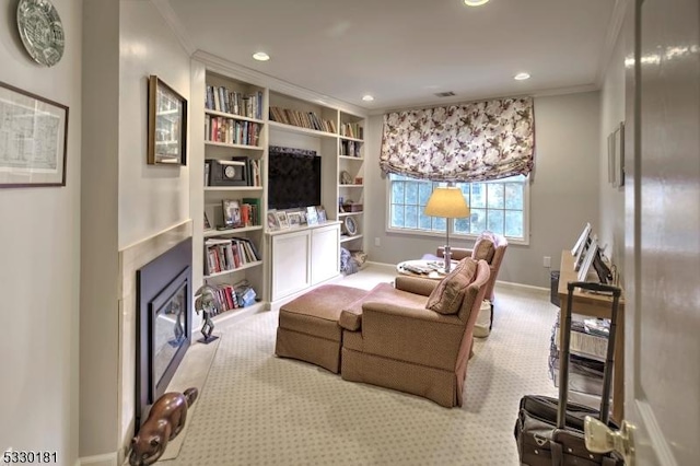 living area with ornamental molding and light carpet