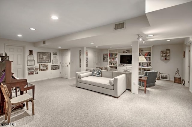 living room featuring light carpet and built in shelves