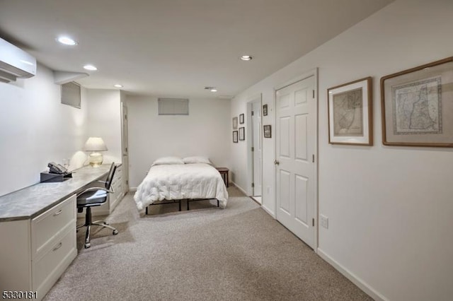 bedroom featuring a wall mounted AC and light carpet