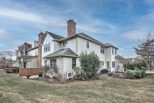 rear view of house featuring a lawn