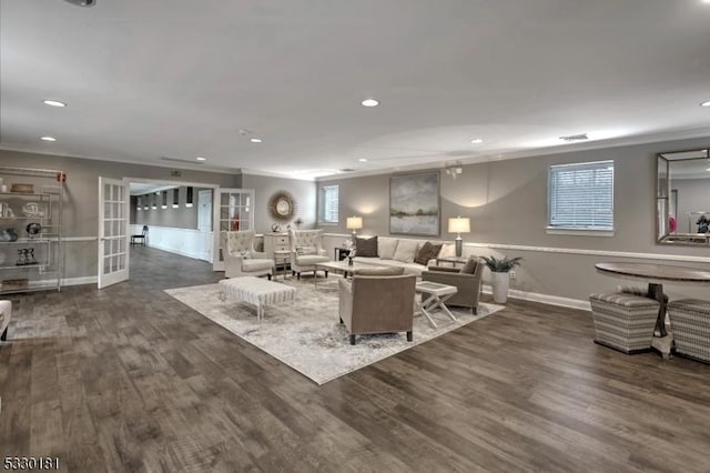 living room with french doors, crown molding, and dark hardwood / wood-style floors