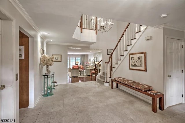 entrance foyer with an inviting chandelier and ornamental molding