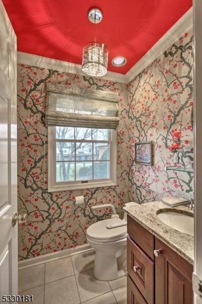 bathroom with ornamental molding, tile patterned flooring, vanity, and toilet