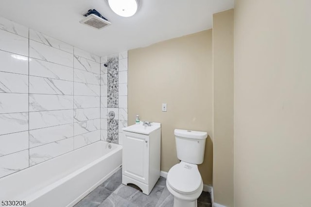 full bathroom featuring sink, tiled shower / bath combo, and toilet