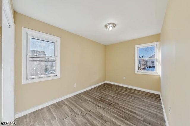 spare room with hardwood / wood-style floors