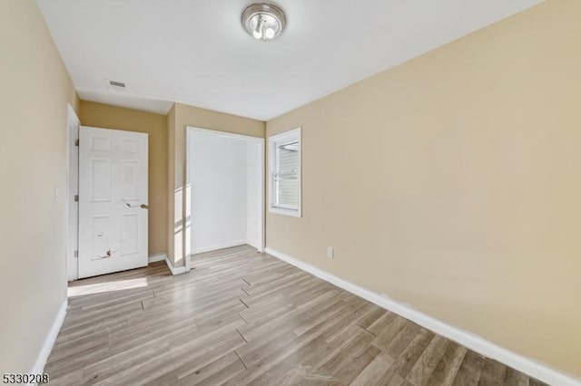 unfurnished bedroom with light wood-type flooring