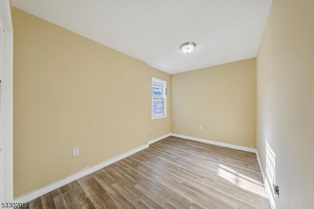 empty room with light hardwood / wood-style floors