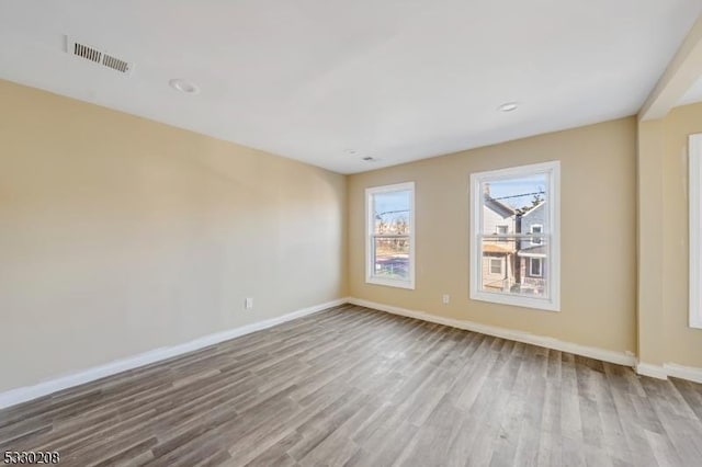 empty room with light hardwood / wood-style flooring