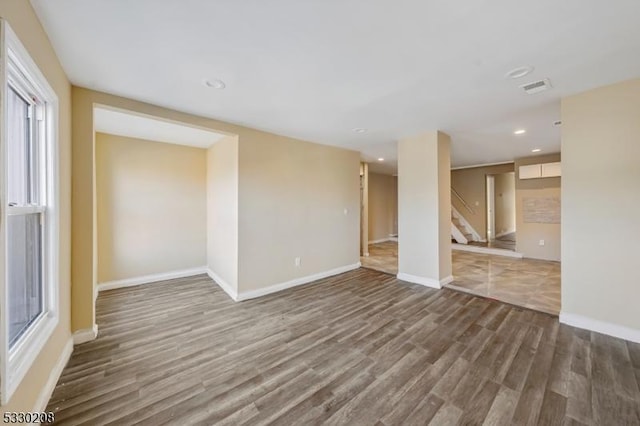 unfurnished room with dark hardwood / wood-style flooring