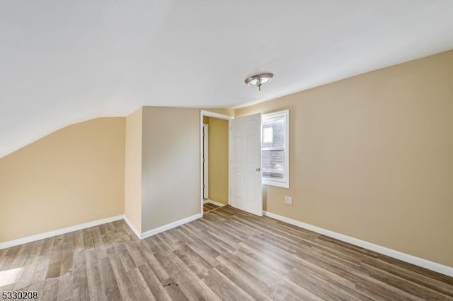 interior space featuring vaulted ceiling and light hardwood / wood-style flooring