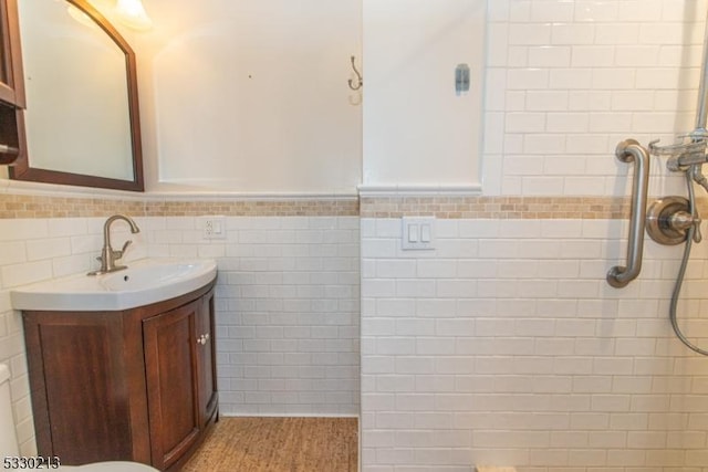 bathroom with vanity and tile walls