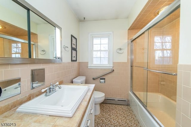 full bathroom featuring shower / bath combination with glass door, toilet, tile walls, and a baseboard heating unit