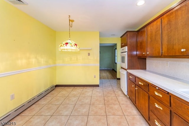 kitchen with white appliances, decorative backsplash, a baseboard radiator, decorative light fixtures, and light tile patterned flooring