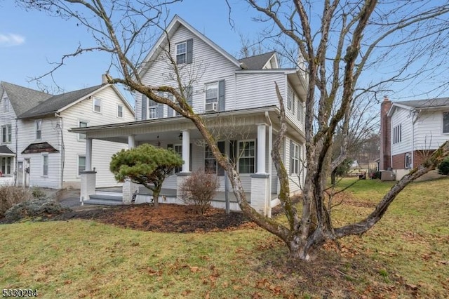 view of front facade with a front lawn and covered porch