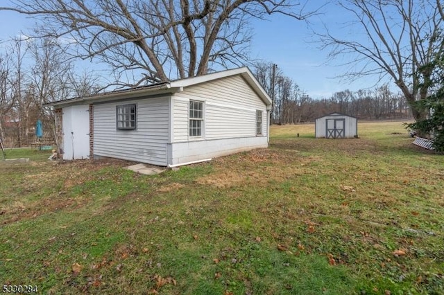 view of home's exterior featuring a storage unit and a lawn