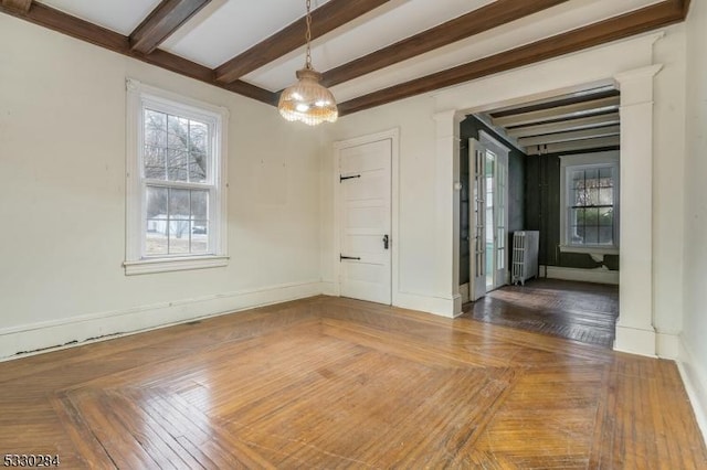 unfurnished dining area with beamed ceiling and radiator