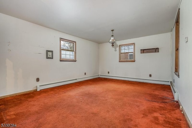 carpeted empty room with baseboard heating