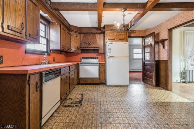 kitchen featuring radiator, sink, a notable chandelier, decorative light fixtures, and white appliances