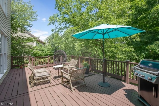 wooden terrace with a grill