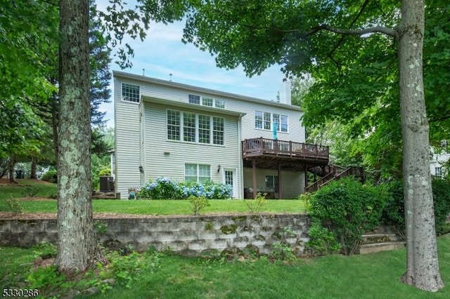 rear view of property with a deck, a yard, a chimney, and stairs