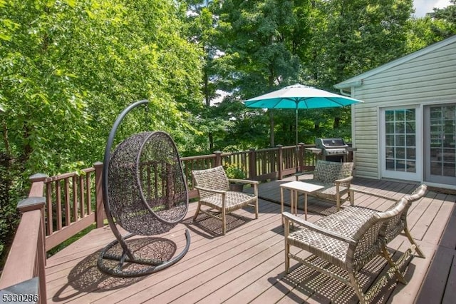 wooden terrace featuring a grill