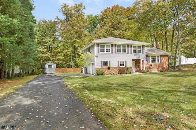 view of front of property with a front lawn and a shed