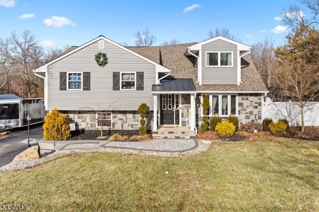 split level home featuring a front yard and a sunroom