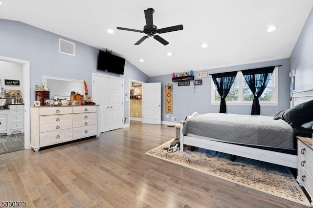 bedroom featuring hardwood / wood-style floors, ceiling fan, and lofted ceiling