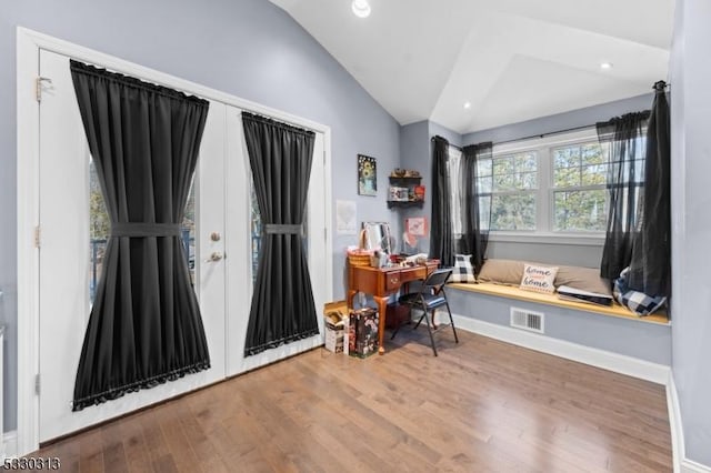 foyer featuring hardwood / wood-style flooring, french doors, and vaulted ceiling