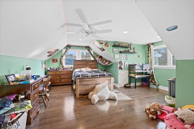 bedroom with ceiling fan, wood-type flooring, and vaulted ceiling