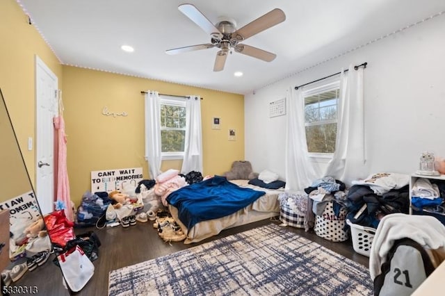 bedroom featuring multiple windows, ceiling fan, and hardwood / wood-style flooring