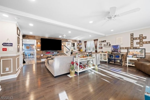 living room with beam ceiling, crown molding, and dark wood-type flooring