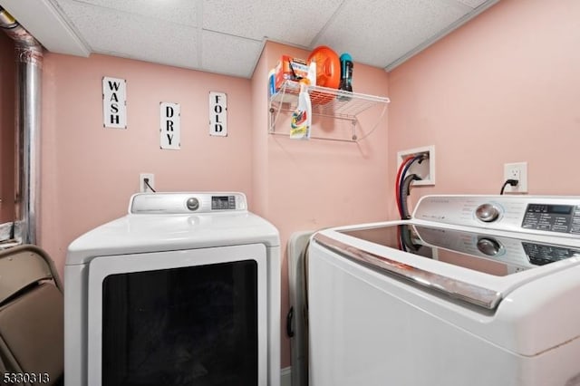 clothes washing area with washing machine and dryer