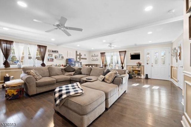 living room with beam ceiling, crown molding, ceiling fan, and dark wood-type flooring