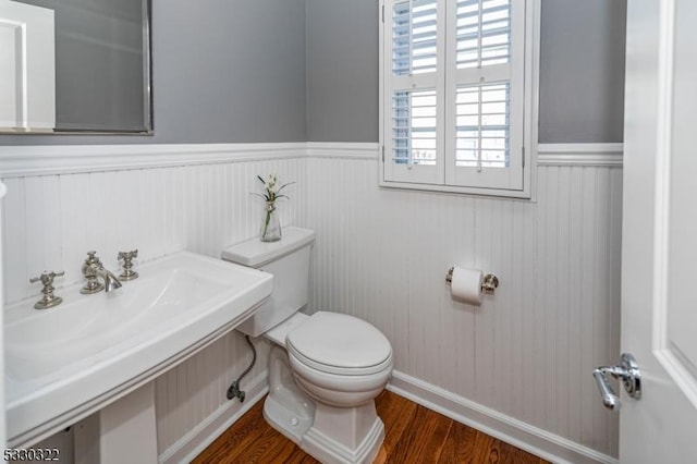 bathroom featuring hardwood / wood-style flooring, toilet, and sink