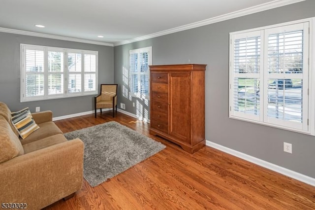 sitting room with crown molding and hardwood / wood-style floors