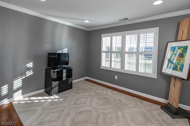 misc room featuring crown molding and light hardwood / wood-style flooring