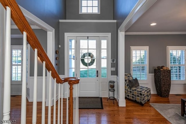 entryway with hardwood / wood-style flooring and ornamental molding