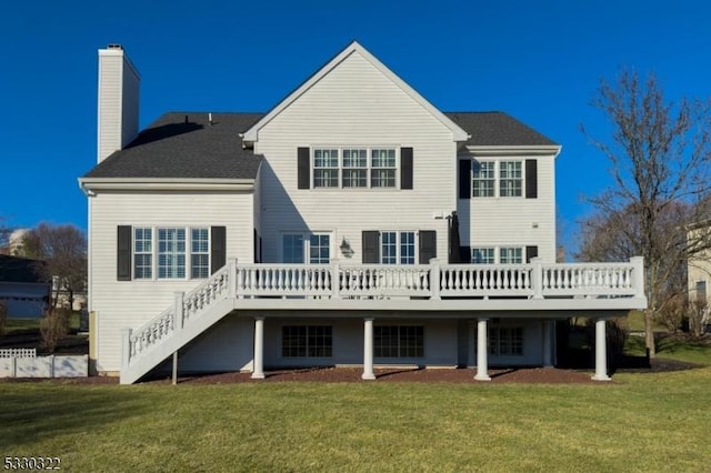 rear view of property with a lawn and a deck