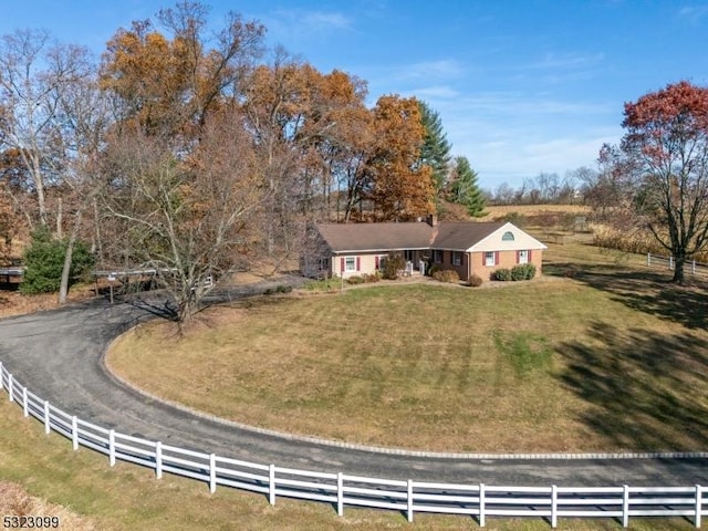 view of front facade with a front yard and a rural view