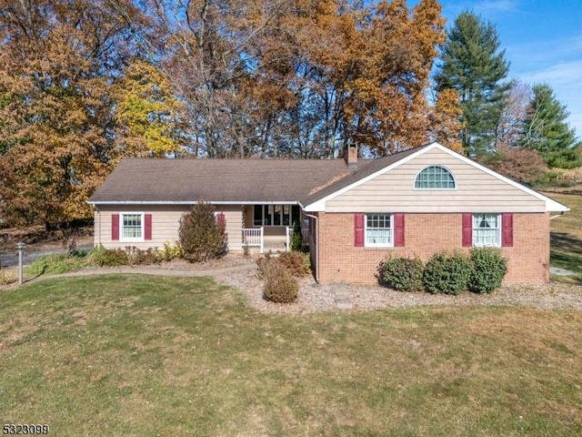 ranch-style house with covered porch and a front yard